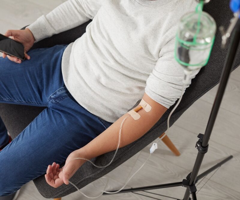 Patient receiving professional IV hydration therapy in a comfortable setting, delivering fluids and nutrients directly into the bloodstream for fast hydration, energy, and recovery support – IV hydration therapy