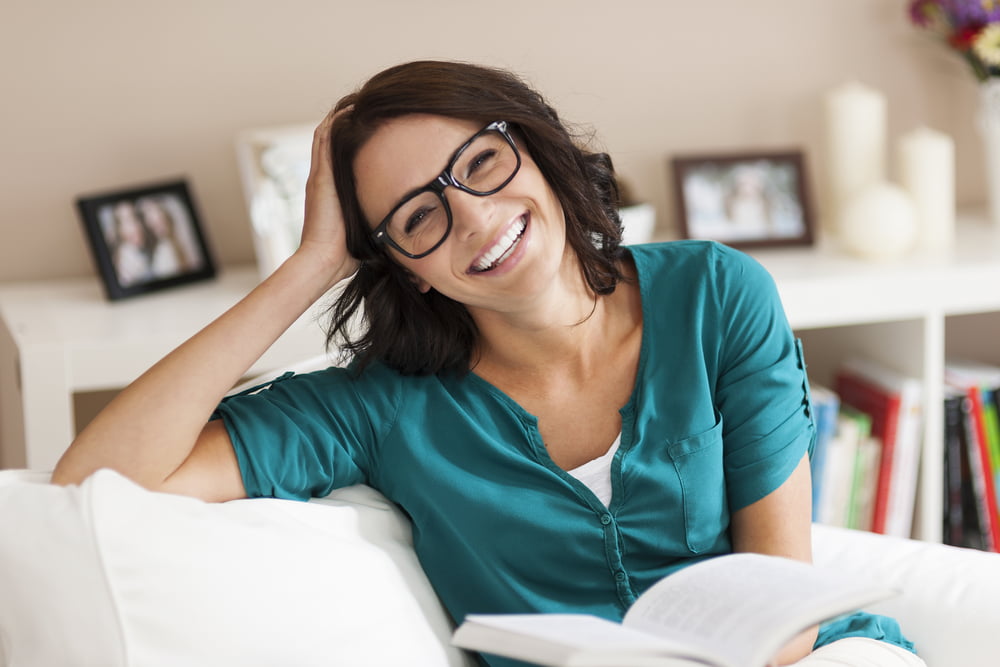Portrait of a happy woman reading a book - Sick Visits in Sheridan, WY Portrait of a happy woman reading a book - Sick Visits in Sheridan, WY